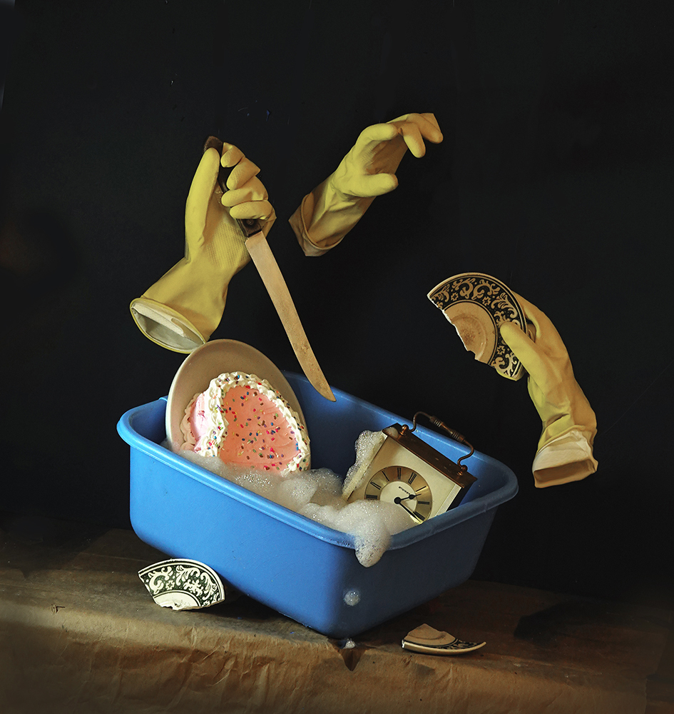 Surrealism, dream, still life, gloves, rubber gloves, yellow gloves, dishpan, washing up, dish washing, suds, foam, cake, heart shaped cake, clock, disorder, rebellion, vandalism, knife, threaten, break, broken dish, chinaware